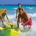 Hotel Riu Tequila in Playa del Carmen guests running into the ocean with a yellow kayak