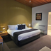Tall Timbers Tasmania room in Smithton with king bed, wood ceiling and attached bathroom doorway