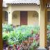 Hotel Mediterraneo Plaza in San Salvador courtyard with lush tropical plants and covered walkway