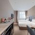 Motel Shanghai Liuzhou Road Guangda Convention And Exhibition Centre room with two beds and vanity in Shanghai