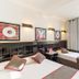Hostal Athenas in Sant Adrià de Besòs offers a twin room with two beds, wall art, and a window.