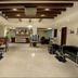 Hotel Impress By Rmr Hotels in New Delhi lobby with seating, reception desk and ceiling beams