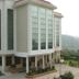 Legend Sarovar Portico Baddi in Baddi, exterior of a modern white hotel with tall glass windows and a landscaped entrance