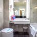 c-hotels Concorde Milan bathroom with vanity, mirror, bathtub and toilet
