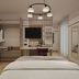 Hotel Taormina in Bardolino guest room with bed, wardrobe, desk, and wall-mounted TV