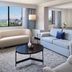 Hilton Washington DC/Rockville Executive Meeting Center guest suite with seating area and city view