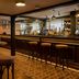 The White Horse in Dorking bar interior with stools, wooden tables and mirrored back bar