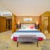 Aile Crown Holiday Hotel in Quanzhou, spacious guest room with king bed and bench