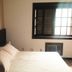 Maratea Mare guest room in Florianopolis with bed, pillows, window, and air conditioner