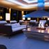 Hotel Zurserhof in Zürs lounge with modern seating and a central fire feature under a large hood