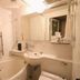 Hiroshima Ekimae Green Hotel bathroom with bathtub, sink, mirror, and shower in Hiroshima