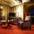 Ekesparre Boutique Hotel in Kuressaare lounge with two armchairs, TV, floor lamp and red carpet
