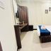 Hotel Ashoka Palace Near Igi Airport, New Delhi guest room with bed, desk, and mirror