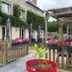 Logis Hôtel Restaurant Auberge Saint Martin in Saint-Gatien-des-Bois with ivy-covered facade and flower-filled patio