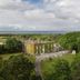 Hardwicke Hall Manor Hotel in Hartlepool surrounded by lush trees with distant sea views