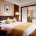Yidu Jinling Grand Hotel Yancheng bedroom with king bed and ensuite bathroom view