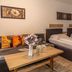 Apparthotel Alte Innbrücke guest room with two beds, sofa, and coffee table in Neuhaus am Inn