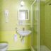 Terme Miramonte e Mare bathroom with shower, sink, bidet and green-tiled walls in Casamicciola Terme