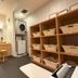 Hotel Route Inn Hakata Ekimae Fukuoka laundry room with washing machines, counters, stools and basket shelves