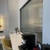Palladion Boutique Hotel in Árgos guest room with bed, desk, chair and frosted glass partition
