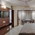 Hotel Centra-Ahmedabad room in Ahmedabad with bed, TV, desk and seating area