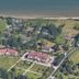 Manoir de la Poterie & Spa in Honfleur, hillside hotel grounds with red-roofed buildings near the coast