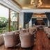Hotel Himalaya Kathmandu lounge with plush seating, wood floors, chandeliers and garden view in Kathmandu