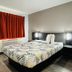 Motel 6-La Mesa, Ca - San Diego guest room with double bed and red curtains in La Mesa