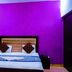Hotel Ashoka Palace Near Igi Airport, New Delhi room with bed, purple accent wall and bedside table