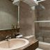 Neuilly Park Hotel bathroom with sink, mirror, and shower-tub combo in Neuilly-sur-Seine