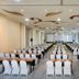 Harris Hotel & Residences Sunset Road Kuta conference room with rows of banquet tables and white chairs