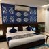 Hotel Impress By Rmr Hotels in New Delhi guest room with bed, sofa, and coffee table