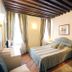 Art Palace - Residenza Giardini, Venice guest room with double bed, wood beam ceiling and wardrobe