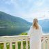 Hofslund Fjord Hotel in Sogndal, woman on balcony overlooking fjord and mountains