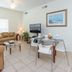 Villas at Seven Dwarfs Lane Resort in Kissimmee living room with sofa, TV and dining table