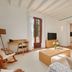 Es Figueral Nou Hotel Rural & Spa in Montuïri living room with sofa, coffee table, desk and TV