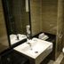 Dunhe Apartment Guangzhou bathroom with sink, toilet, mirror and walk-in shower
