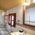 Casa de Aldea La Pumariega bathroom with bathtub, toilet, window and mirror in Oviedo