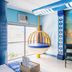 Hotel Dreamworld Araneta Cubao in Manila room with hanging egg chair, TV, desk and ocean-themed wall art