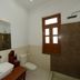 Hotel Harasar Haveli bathroom in Bikaner with vessel sink, toilet, mirror and window
