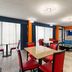 Super 8 by Wyndham Bulls Gap Greeneville Area lobby with red chairs, blue sofa and large windows