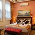Emirhan Inn Hotel, Sultanahmet Istanbul room with double bed, bedside lamps, window and wall art