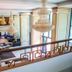 Hotel Del Mar & Conference Center in Mamaia lobby with chandeliers, balcony railing, and tiled seating area
