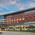 Sheraton Suites Akron Cuyahoga Falls exterior at dusk with modern glass entrance and brick facade