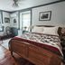 Osceola Mill House B&B in Gordonville, cozy guest room with wood bed, quilt, windows and vintage decor