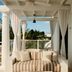 Palm Heights North Side cabana with striped daybed and palm tree view
