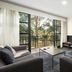 Quest Narre Warren lounge with balcony doors and tree view