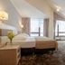 Hotel Diament Ustron room in Ustroń with king bed, seating area, and large windows