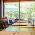 Resort Bad Boekelo dining room with large windows overlooking a green terrace in Boekelo