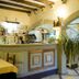 Hotel San Francisco in Dorgali bar area with arched stone details, wood beams, and a drink counter